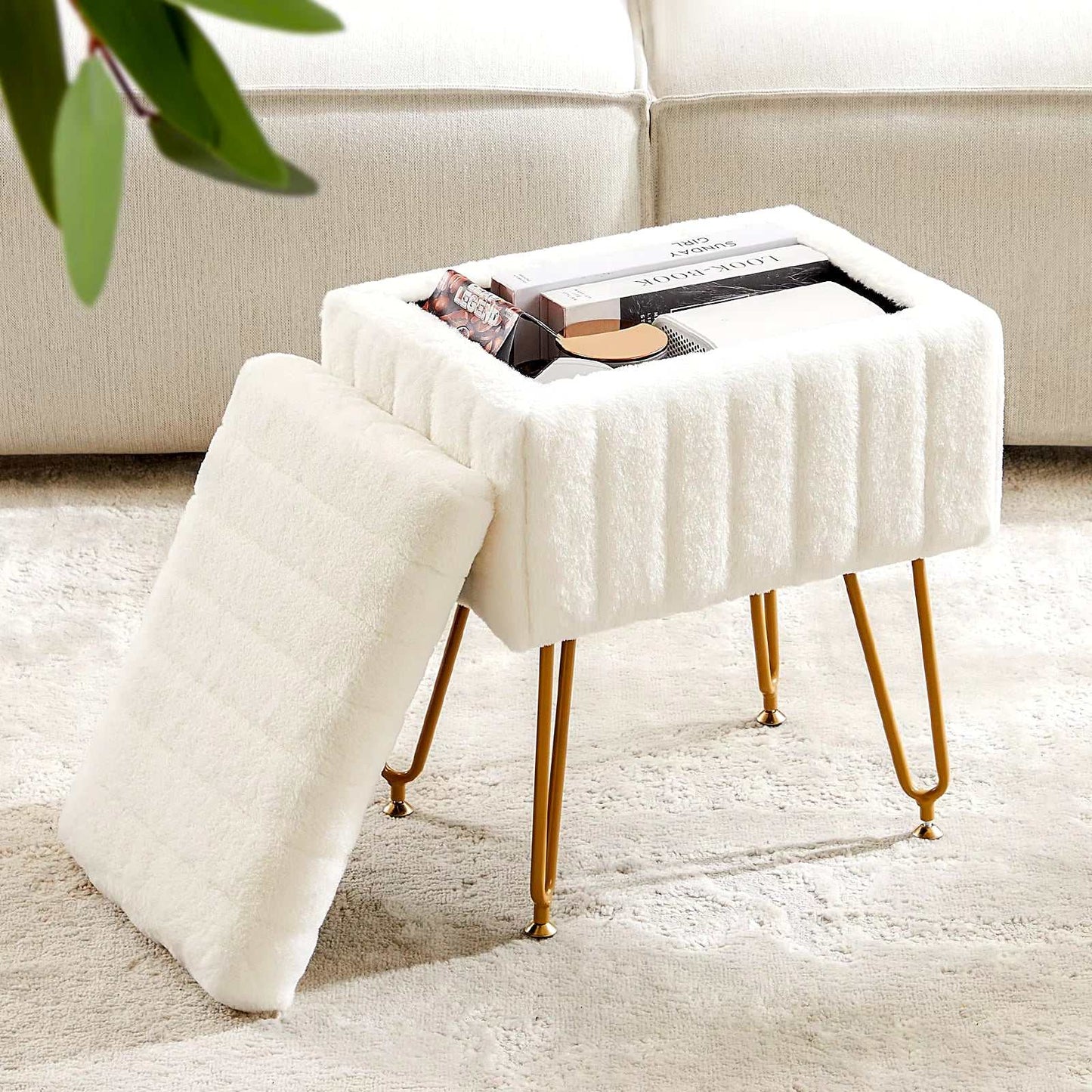 White faux fur living room storage stool with gold metal legs and removable padded lid.