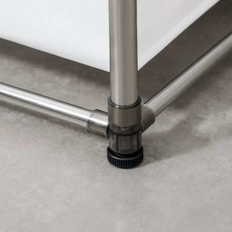 Close-up of Laundry Hamper 2 Tier metal frame corner with adjustable black foot on grey floor