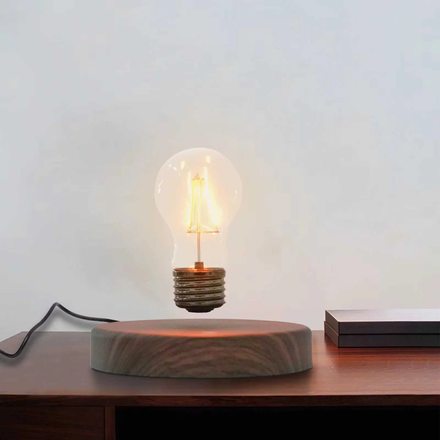 Magnetic levitating light bulb floating above wooden base, warm light decoration lamp with 12V wireless power.