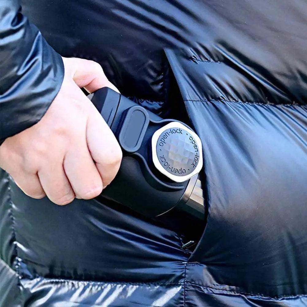 Handheld portable espresso maker being placed into a jacket pocket for travel and outdoor use