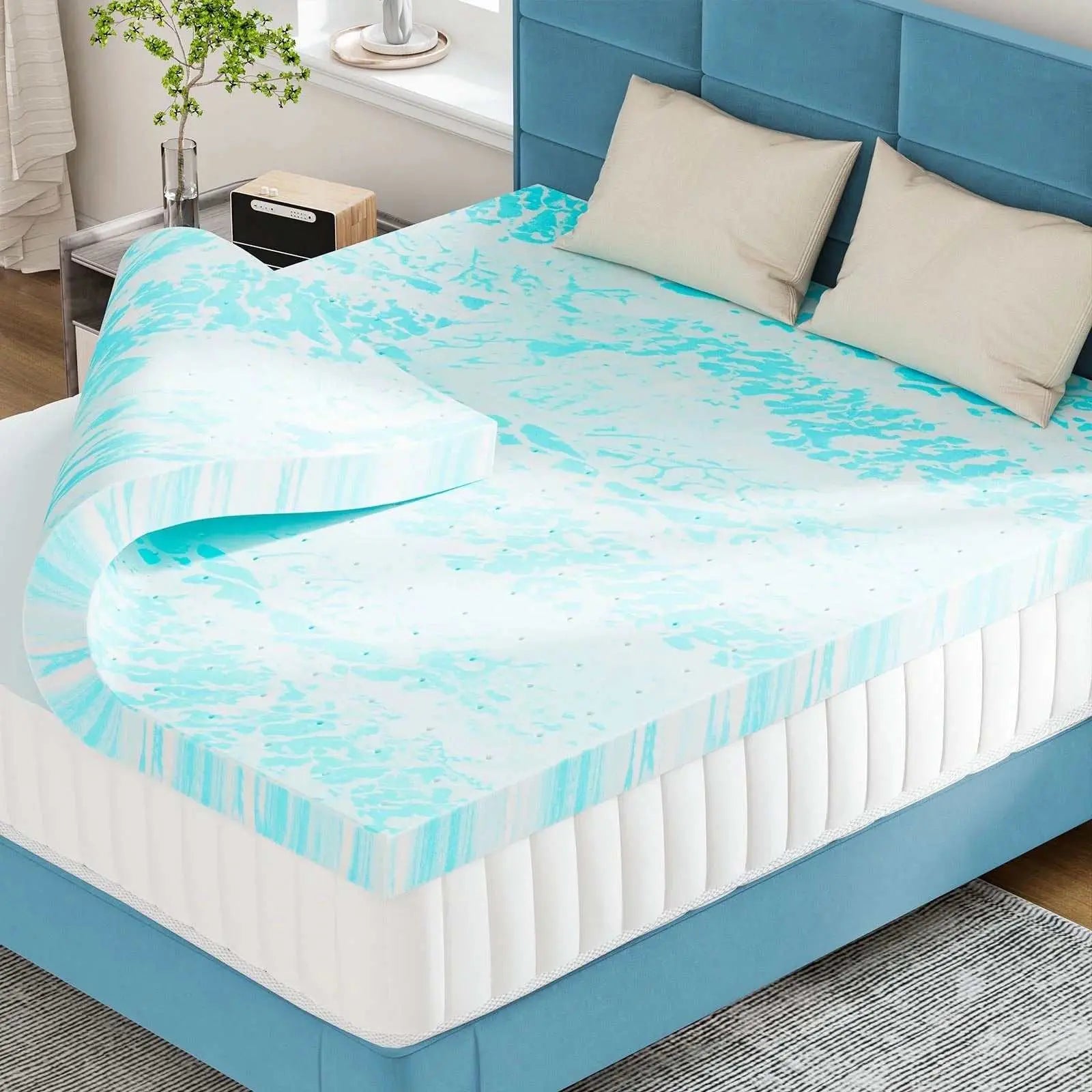 3-inch cooling gel memory foam mattress topper on bed with blue upholstered headboard and beige pillows
