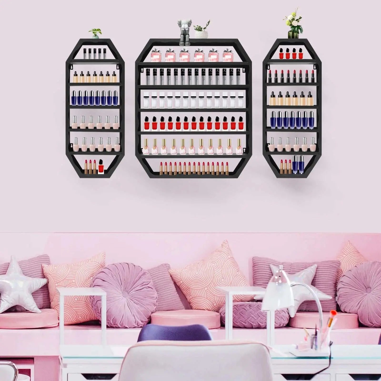 Modern multi-tiers wall-mounted black nail polish storage racks displayed on a pink wall above a pink-themed cozy seating area.