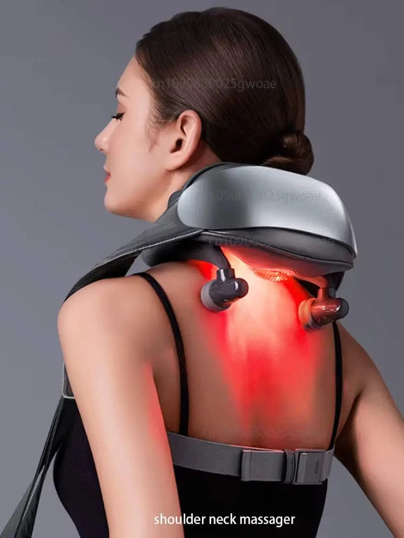 Woman using a gray neck shoulder massager with heat and rotating nodes for deep tissue muscle relief