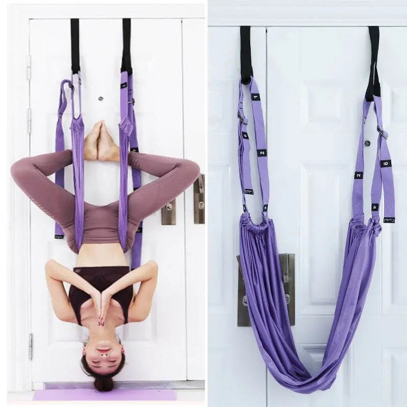 Purple fitness hip stretch yoga belt hanging on door for inverted stretching exercises