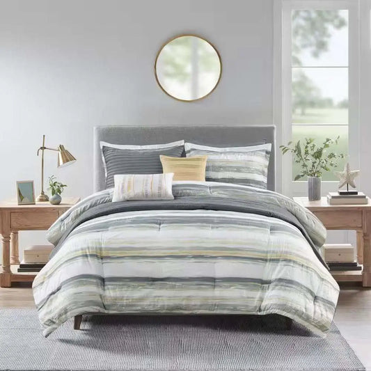 Anchorage 8-Piece Comforter Set with textured seersucker, watercolor stripe print in yellow and gray, including comforter, shams, decorative pillows, and quilt on modern bed.