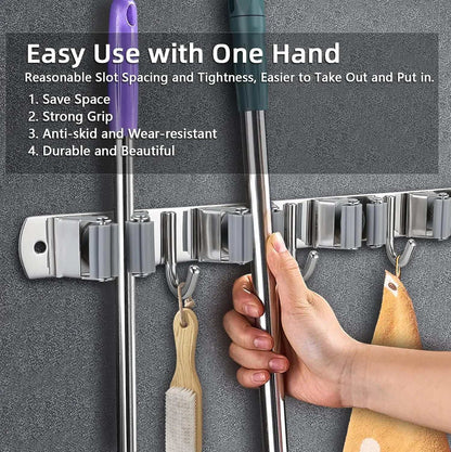 Stainless steel broom holder wall mount with rubber rollers for easy one-hand use, heavy-duty storage for brooms, mops, and cleaning tools.