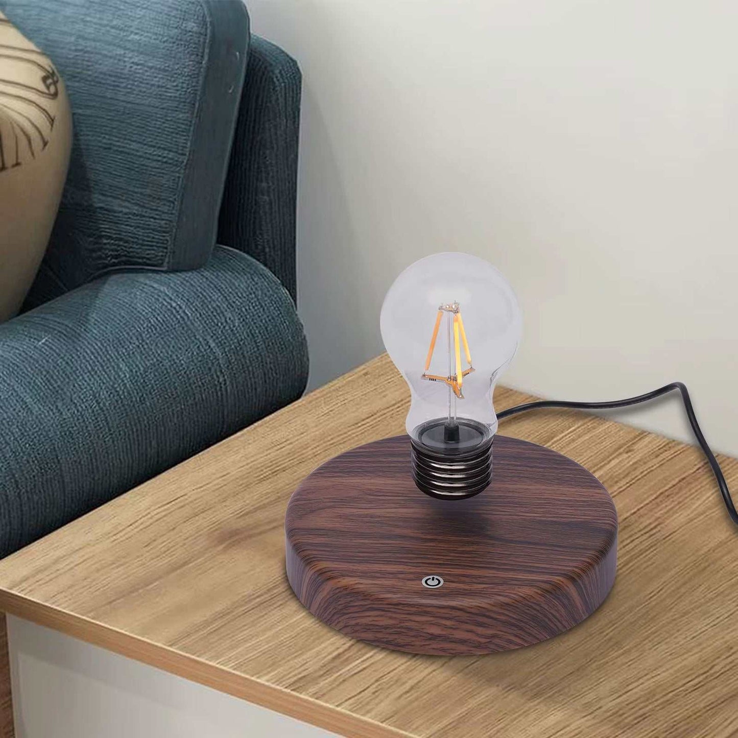 Magnetic levitating light bulb floating above wooden base on table next to sofa