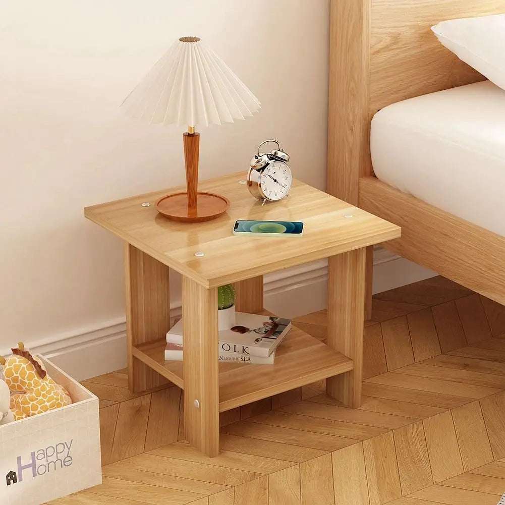 Simple solid wood bedside table with double-layer design, lamp, clock, and phone on top beside bed in modern bedroom