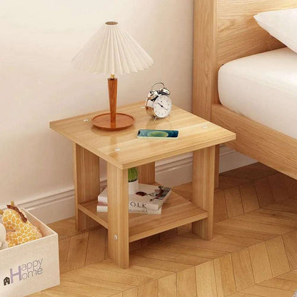 Simple solid wood bedside table with double-layer design, lamp, clock, and phone on top beside bed in modern bedroom