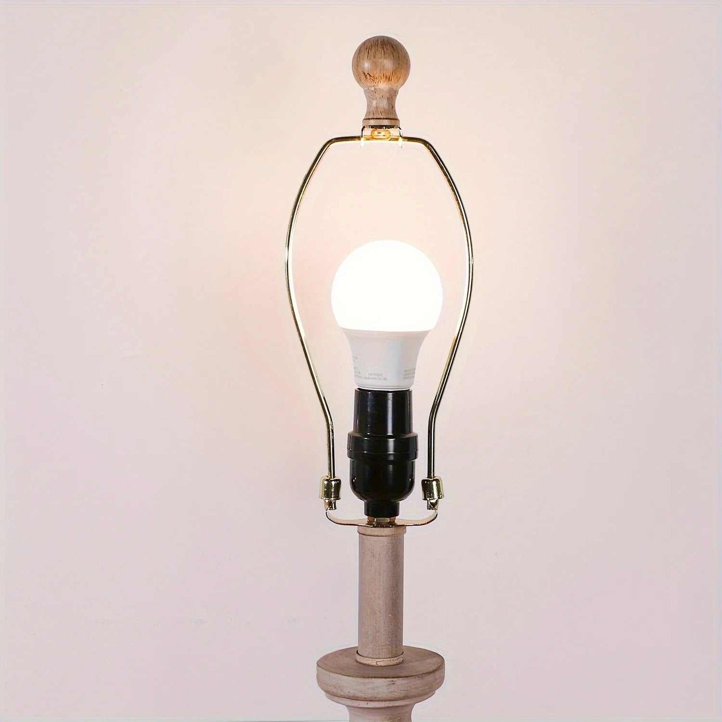 Coastal candlestick table lamp with wooden base and LED bulb on white background