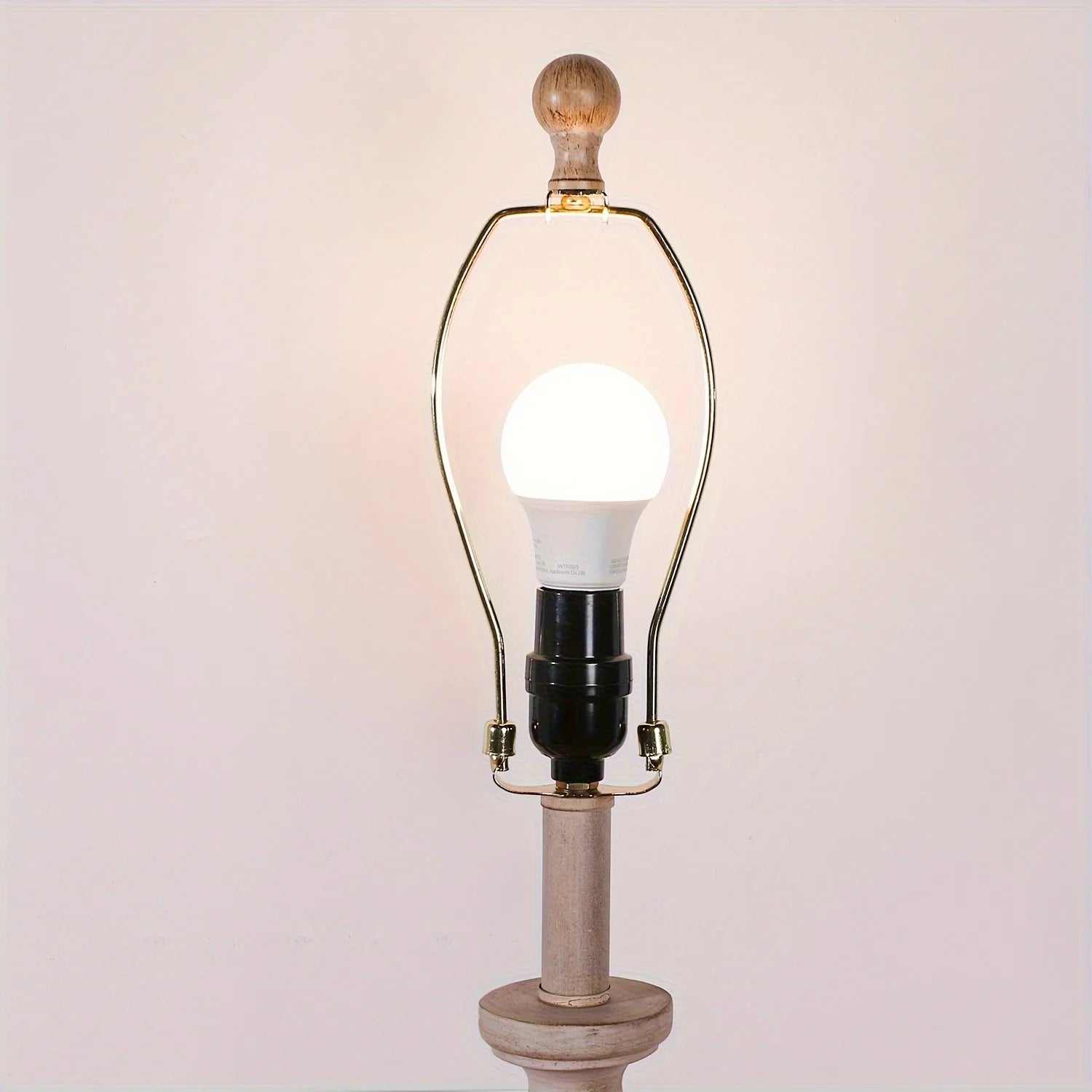 Coastal candlestick table lamp with wooden base and LED bulb on white background