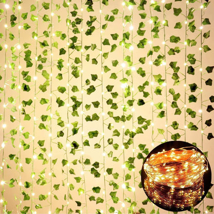 12 pack fake vines with LED string lights hanging for room decor, artificial green ivy leaves on plastic strands creating a natural aesthetic ambiance.