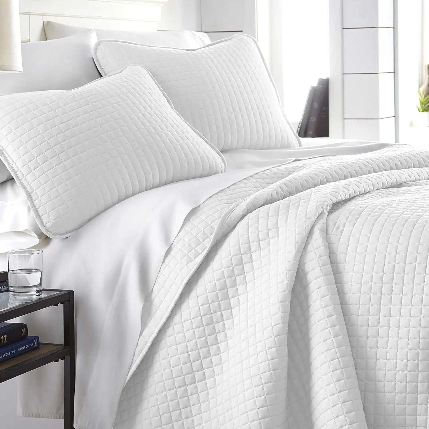 White King Quilt Set with square stitched quilt and two matching pillow shams on bed