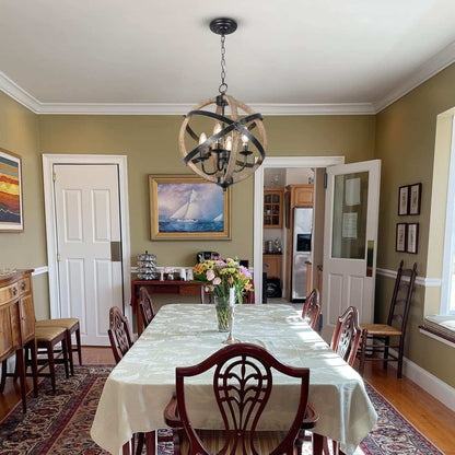 Rustic farmhouse chandelier lamp with adjustable height and wood-metal design hanging over dining table
